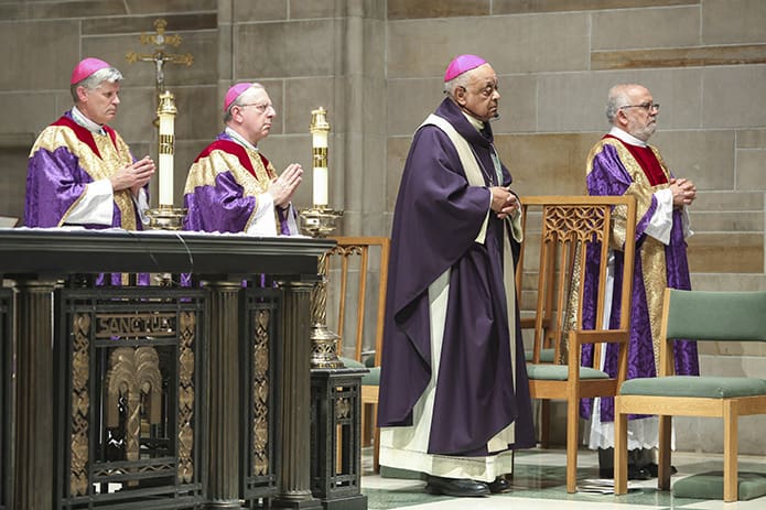 (L-r) Bishop Bernard E. Shlesinger III, Bishop Joel M. Konzen, SM, Archbishop Wilton D. Gregory and Deacon José Espinosa, associate co-director of formation for the Office of the Permanent Diaconate, stand for the reading of the Gospel during the April 10 Mass of Reparation at Cathedral of Christ the King, Atlanta. Photo By Michael Alexander
