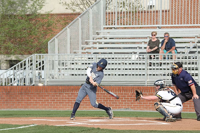 St. Pius X outfielder Mike Spear swings at an oncoming ball, but he was unable to get on base during his first at bat during the April 11 game against Marist School. Photo By Michael Alexander