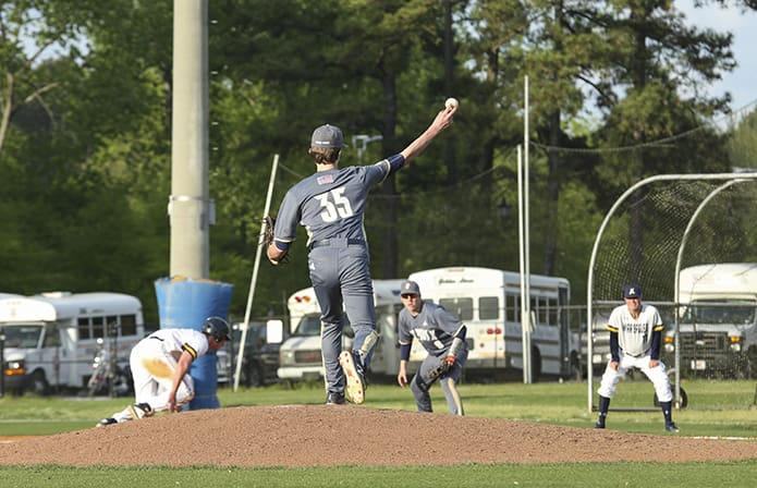 Taz Butler (#35), the fourth pitcher used by St. Pius X during the April 11 game, throws over to first base in an attempt to pick off Marist School right fielder Tyler Hare. Photo By Michael Alexander