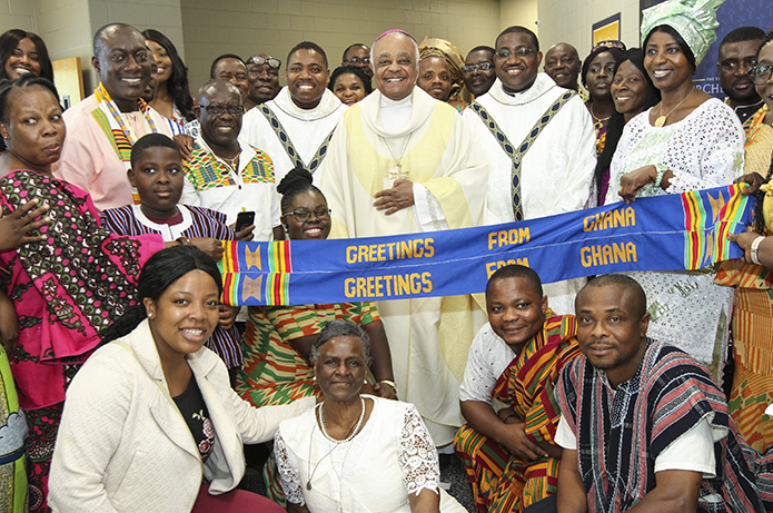 Archbishop Wilton D. Gregory, center, poses for a photograph with the Ghanaian Catholic Community after his April 28 farewell Mass at Marist School’s Centennial Center. Photo By Michael Alexander