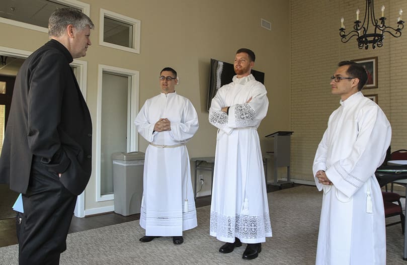 Prior to getting vested, Bishop Bernard E. Shlesinger III, left, greets the transitional diaconate ordination candidates, (l-r) Cristian Cossio, Paul Porter and Miller Gómez Ruiz before they all make their way over to the Cathedral of Christ the King, Atlanta. Photo By Michael Alexander