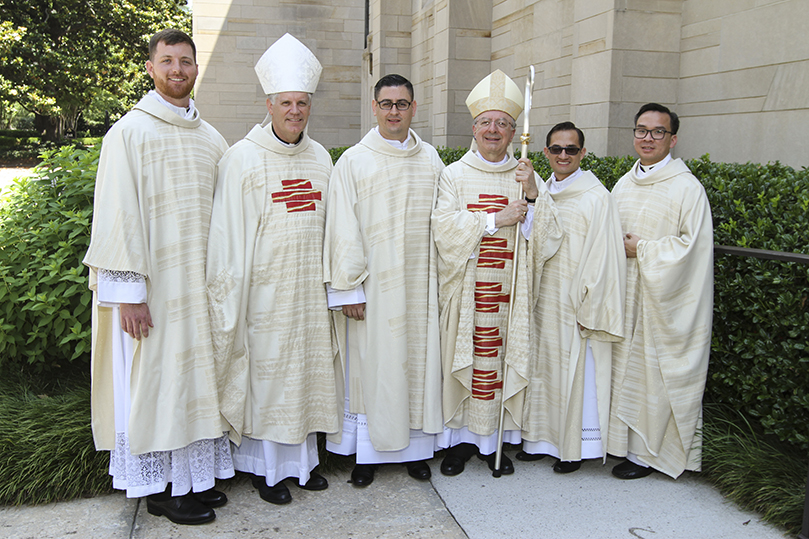 Bishop Bernard E. Shlesinger III, second from left, Bishop Joel M. Konzen, SM, third from right, and Father Tri John-Bosco Nguyen, far right, director of vocations, pose for a post-ordination photo with the new deacons (l-r), Paul Porter, Cristian Cossio and Miller Gómez Ruiz. Photo By Michael Alexander
