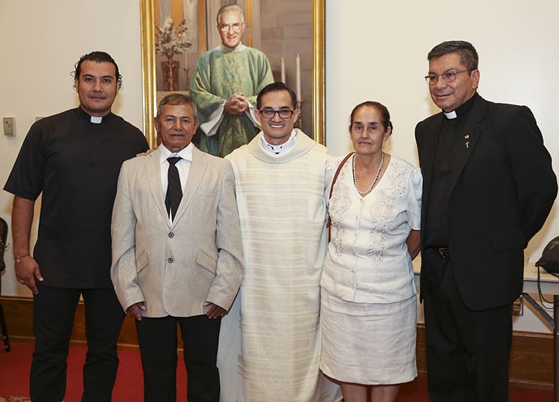 Deacon Miller Gómez Ruiz, center, is captured in a photo with his parents, Carlos Alberto and Aurelia, along with two priests from his native country of Colombia, Father Ricardo Fernandez, left, and Father Fernando Floriano, right. Photo By Michael Alexander