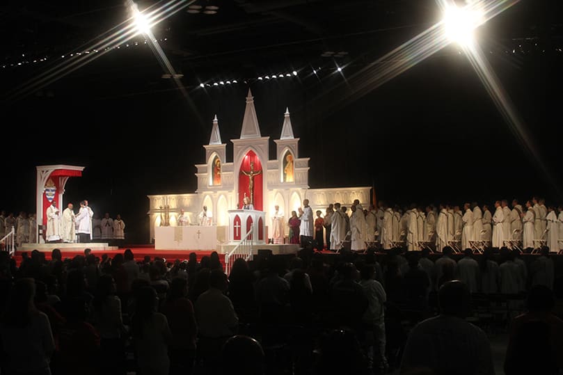 The closing Mass unfolds during the 2014 Eucharistic Congress. JJA Project Management is responsible for building the stage and setting up the altar, ambo, cathedra and the church-like backdrop. Many of these items are stored away in a trailer until they start setting up for the event two days prior to its start. They also provide the lighting, sound, video, staging and a host of other things. Photo By Michael Alexander