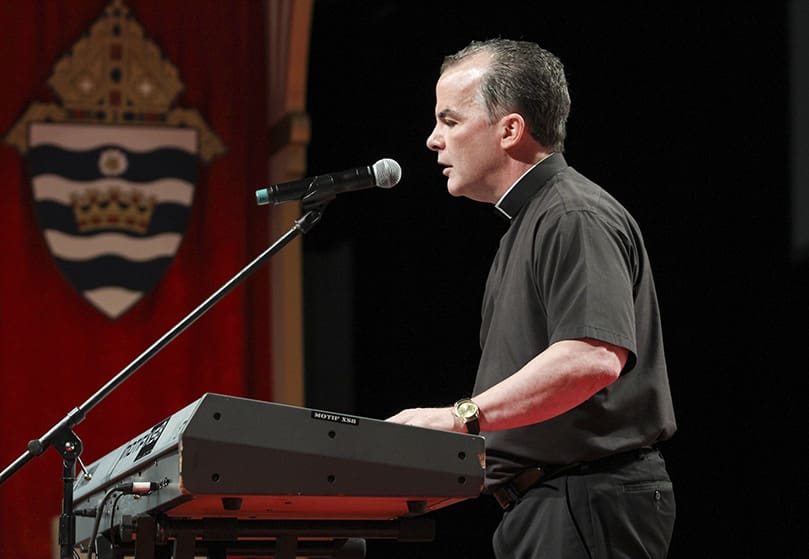 Father Mike Joly, pastor of St. Joan of Arc Church, Yorktown, Virginia, preached, sang and played the keyboards during his time in the English track. Father Joly has been totally blind since age six, and he became interested in music as teenager. Photo By Michael Alexander