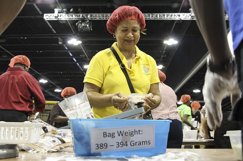 Mary Welsh, a member of Most Blessed Sacrament Church, Atlanta, seals the bags of packaged meals. Welsh has attended Starve Wars three of its four years. Photo By Michael Alexander