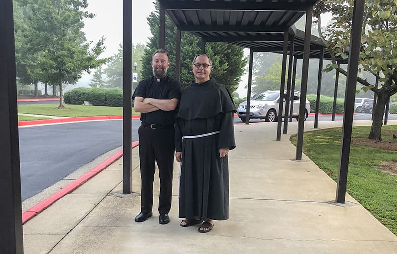Father Kevin Hargaden, left, pastor of St. Matthew Church, Tyrone, and Father John Koziol, OFM Conv., pastor of St. Philip Benizi Church, Jonesboro, were on hand for the first day of school at Our Lady of Victory. Father Hargaden’s parish and the school share the same grounds, and several families from Father Koziol’s parish also attend the school. Photo By Diane Starkovich, Ph.D.