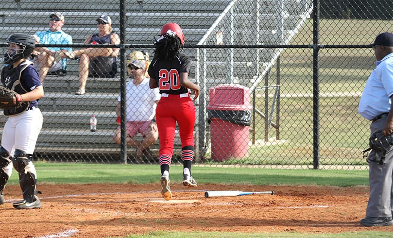 Khalani Roundtree’s second inning base hit allowed Assata Eaton (#20) to cross home plate for the team’s first run of the game. Photo By Michael Alexander