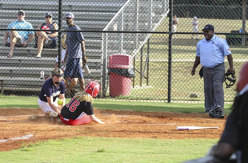 During the second inning of the Sept. 25 game against Alpharetta's St. Francis School, Our Lady of Mercy High School freshman third baseman Melanie Brook (#16) slides safely into home plate. Our Lady of Mercy defeated St. Francis 13-1. Photo By Michael Alexander