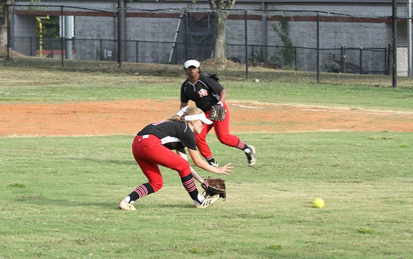 Junior shortstop Sophia Launay makes a play on a ground ball. In the background looking on is her sophomore teammate and second baseman Anjali David. Photo By Michael Alexander