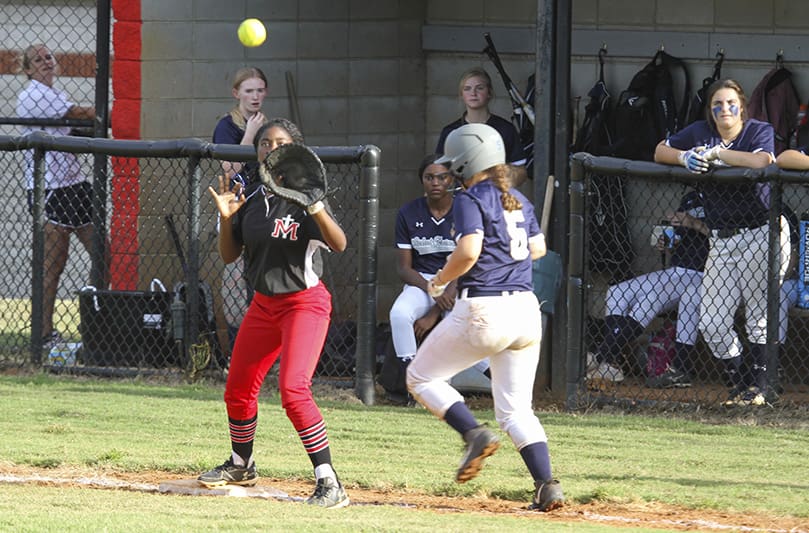 Assata Eaton, left, is on the receiving end of a throw from the team’s shortstop Sophia Launay. With two outs in the inning, they were trying to close out the inning, but St. Francis School's Ava Margavio touches the bag before the ball reaches Eaton's glove. Photo By Michael Alexander