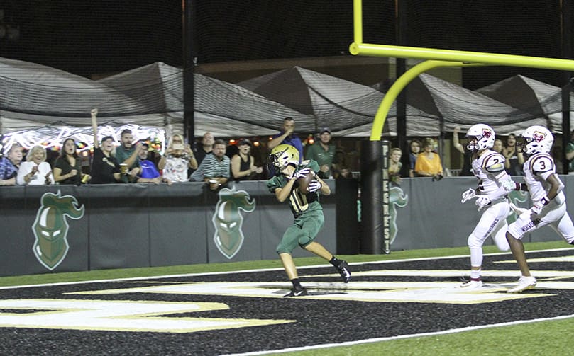 With just over a minute before halftime, Pinecrest Academy wide receiver Breckin Barbee comes down in the end zone with a touchdown pass from quarterback Bryce Balthaser. It was Pinecrest Academy's first and only score in a 28-7 loss to The Walker School Sept. 27. Photo By Michael Alexander
