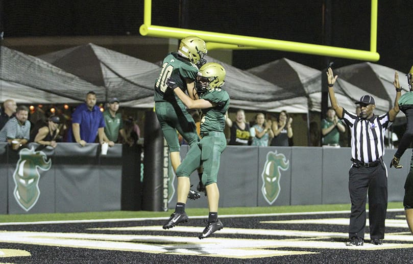 Pinecrest Academy wide receiver Breckin Barbee, left, and his teammate Jay Black, celebrate Barbee’s 26-yard touchdown catch in the end zone. Pinecrest lost its Sept. 27 home game against The Walker School 28-7. Photo By Michael Alexander