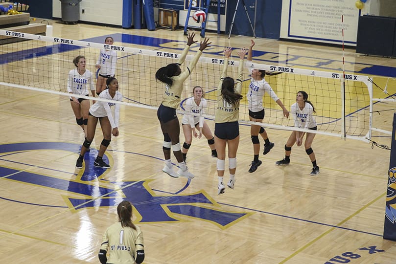 St. Pius X High School’s Sydney Jatio (#4), left, and Ava Pitchford go up to block the shot of Mount Paran Christian outside hitter Angel Ferary (#1) during the first set of the Sept. 24 match. Photo By Michael Alexander