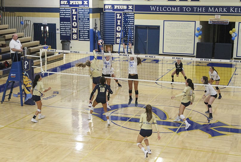 During the third set of the Sept. 24 match against Kennesaw’s Mount Paran Christian, St. Pius X High School sophomore middle blocker Annemarie Rakoski (#18) strikes the ball over the outstretched arms of Mount Paran Christian’s Bella Ferary (#2) and Hannah Pulley (#14). Rakoski had seven kills in St. Pius’ 3-2 victory over Mount Paran Christian. Photo By Michael Alexander