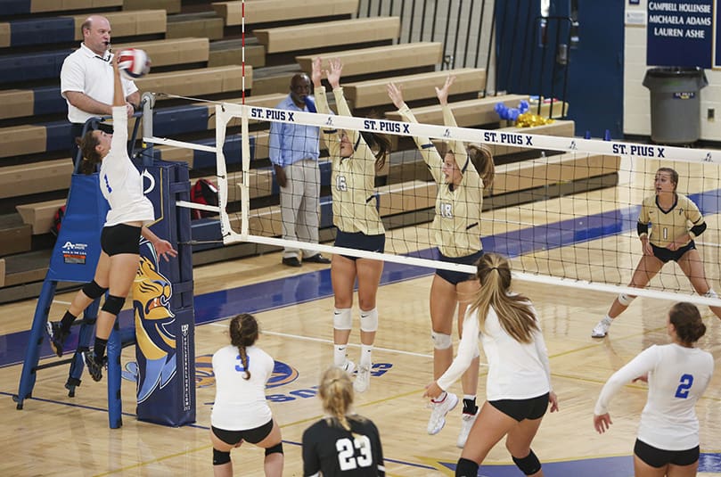 Ava Pitchford (#16) and Annemarie Rakoski (#18) go up to block the shot of Mount Paran Christian outside hitter Angel Ferary (#1) during the fourth set. Both St. Pius players led the team in blocks during the match with four apiece. Photo By Michael Alexander