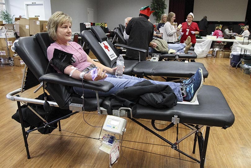 Susan Beck was one of the first people to donate a unit a of blood during the 10th annual Bob Buechner Blood Drive at Holy Cross Church, Atlanta. Beck is a regular participant at the parish blood drive, along with her husband Tim. Holy Cross collected 212 units during the Dec. 7 drive. Photo By Michael Alexander