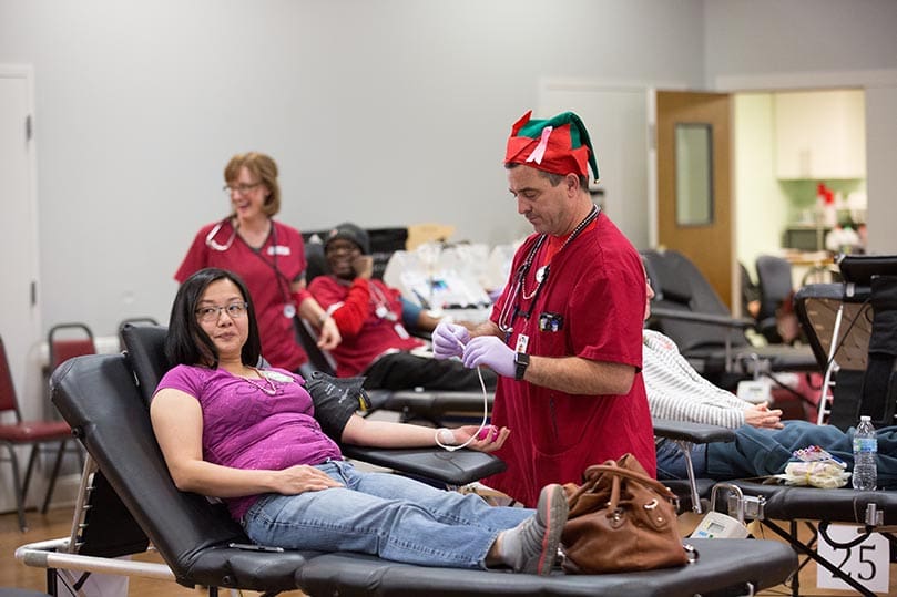 A Holy Cross parishioner prepares to donate a unit of blood. When the blood drive was completed, Holy Cross Church had collected 212 units of blood. Photo By Rob Buechner