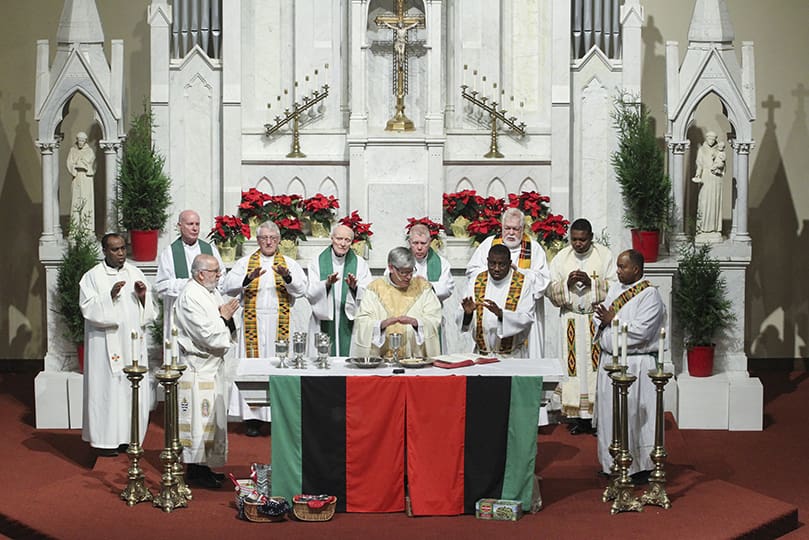 During the Martin Luther King Jr. Eucharistic Celebration at the Shrine of the Immaculate Conception, Atlanta, Bishop Bernard E. Shlesinger III, center, is joined around the altar by his brother clergy. In the absence of an archbishop, this was the first time one of the auxiliary bishops had to serve as the principal celebrant and homilist. Photo By Michael Alexander