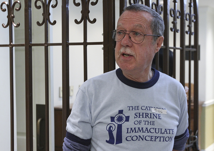 After completing some of the preparation tasks on the morning of Jan. 18, Bill Emery gives some of the first-time St. Francis Table volunteers a brief history of the Shrine of the Immaculate Conception. Emery is the coordinator for St. Francis Table, one of the church's oldest outreach ministries. Photo By Michael Alexander
