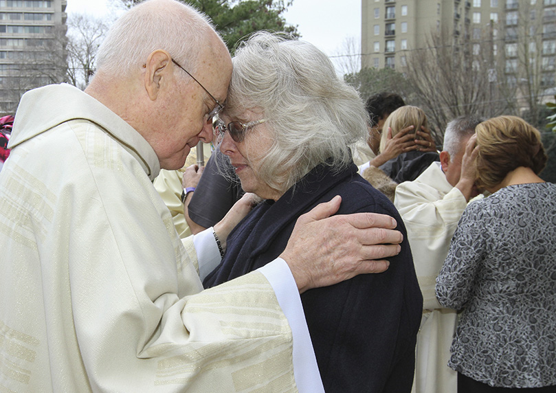 Standing on the plaza by the front entrance to the Cathedral of Christ the King, Atlanta, Deacon Joseph Odom Jr. confers the first blessing to his wife of 47 years, Jacqueline. Odom, the only member of the 2020 diaconate class born in Atlanta, was ordained with seven other men on Feb. 1. Photo By Michael Alexander