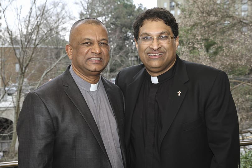 After his Feb. 1 ordination, Dev Lobo, right, a new deacon assigned to Transfiguration Church, Marietta, is joined by his friend of nearly 40 years, Glen Mendonca. The two grew up in the same community and church in Bangalore, India. Mendonca was ordained a deacon in 2007 for the Diocese of Trenton (New Jersey). Photo By Michael Alexander