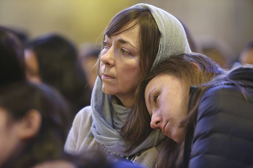 Mary Malinoff, 14, leans on the shoulder of her mother, Delina, as they listen to the homily during the 31st annual Mass for the Unborn at the Cathedral of Christ the King, Atlanta. They are parishioners of All Saints Church, Dunwoody. Photo By Michael Alexander