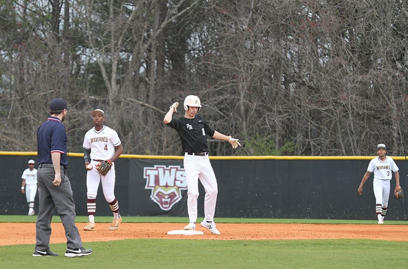 Senior first baseman Caleb Bohn slaps his hands together after getting a two-out double during his first-at-bat in the March 11 game against The Walker School in Marietta.