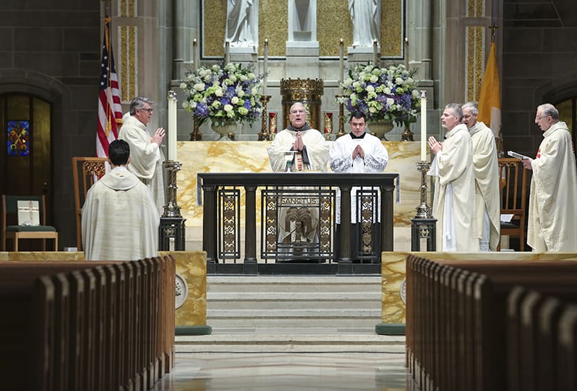 Archbishop Gregory J. Hartmayer, OFM Conv., center, stands before the altar during the Liturgy of the Eucharist. Archbishop Hartmayer officially became the seventh archbishop of Atlanta during his May 6 Mass of Canonical Installation at the Cathedral of Christ the King, Atlanta. Photo By Michael Alexander