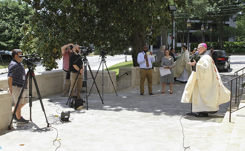 Archbishop Gregory J. Hartmayer, OFM Conv., makes himself available during a post installation press conference at the front entrance to the Cathedral of Christ the King, Atlanta, site of his May 6 Mass of Canonical Installation. Photo By Michael Alexander