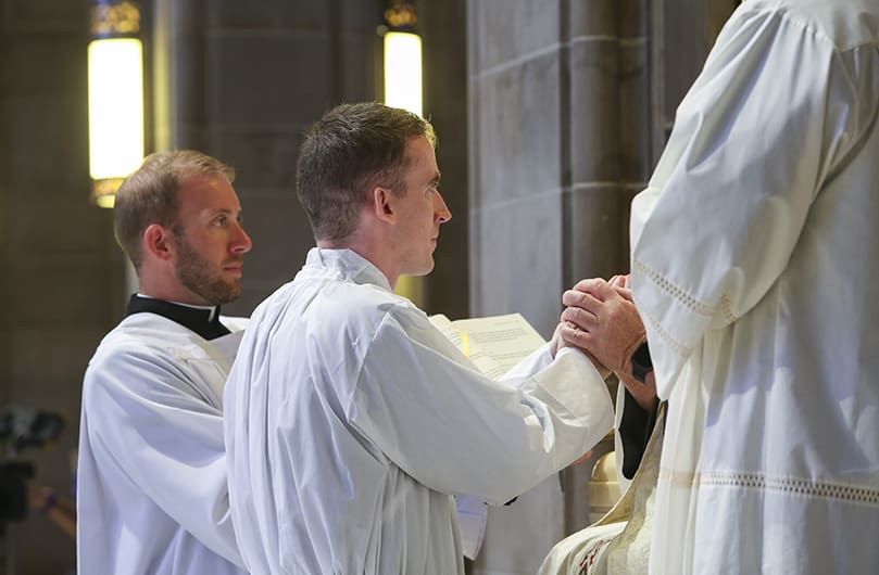 Paul Nacey, second from left, pledges his obedience to Archbishop Gregory J. Hartmayer, OFM Conv., during the June 13 ordination. Photo By Michael Alexander