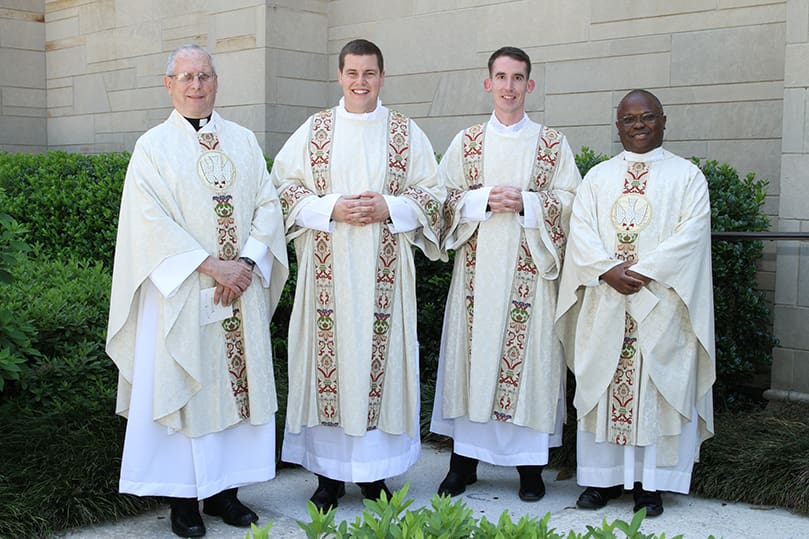 Atlanta's newest transitional deacons, Rev. Mr. Robert Cotta, left center and Rev. Mr. Paul Nacey, right center, are joined by Father Martin Zielinski, associate professor in the Department of Church History at Mundelein Seminary, Mundelein, Ill., far left, and Father Deogratias Ekisa, vice rector of Notre Dame Seminary, New Orleans, La., far right, for a post ordination photograph outside the Cathedral of Christ the King, Atlanta. Cotta and Nacey were ordained June 13. Photo By Michael Alexander