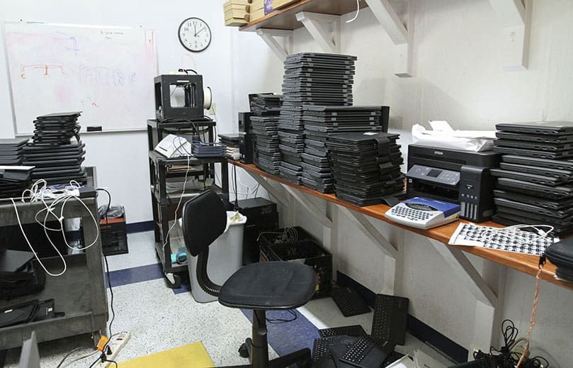 Chromebooks and iPads are piled up in technology maintenance room at St. Thomas More School, Decatur. These devices will be available to all 466 of its students this school year. Photo By Michael Alexander