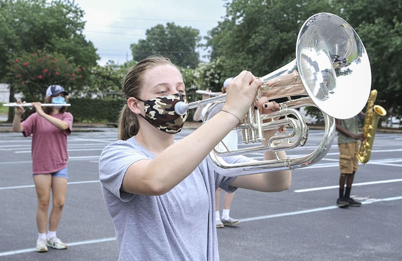 Junior flugelhorn player Jo Jo Nieman was one of the 20 brass and wind players on hand for the July 30 St. Pius X High School marching band sectional practice. It was the final day of band camp. Masks were the added accessory to this year's camp, during a coronavirus pandemic that ended the 2019-2020 school year, and continues to exist as the 2020-2021 school year begins. Photo By Michael Alexander