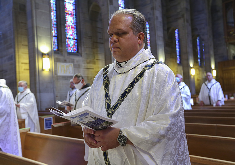 Father Timothy Gadziala pastor of St. Peter Church, LaGrange, renews his priest priestly commitment during the Aug. 17 Chrism Mass. Photo By Michael Alexander