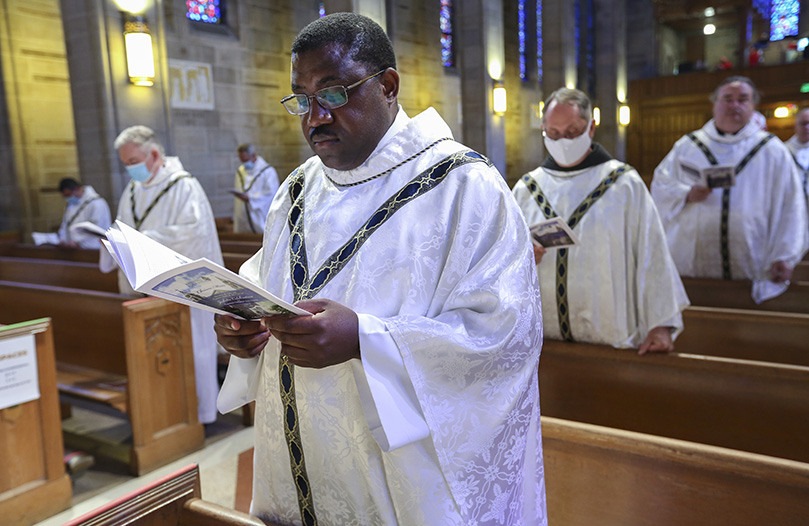 Father Henry Atem, pastor of St. Lawrence Church, Lawrenceville, joins his brothers in the renewal of their priestly commitment during the annual Chrism Mass at the Cathedral of Christ the King, Atlanta. Photo By Michael Alexander