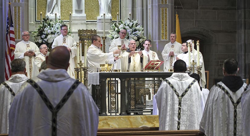 Archbishop Gregory J. Hartmayer, OFM Conv., center, was the main celebrant and homilist for his first Chrism Mass as the archbishop of Atlanta. Standing on the steps in the far background are the silver jubilarians, which included (l-r) Father Lawrence Niese, Msgr. Joseph Corbett, Msgr. Francis McNamee and Father Paul Williams. Photo By Michael Alexander