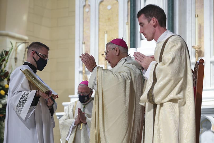 Archbishop Gregory J. Hartmayer, OFM Conv., foreground center, conducts the post Communion prayer. Holding the prayer book is server and seminarian Evan Glowzinski. Standing at the archbishop’s left is assisting deacon Rev. Mr. Paul Nacey. Photo By Michael Alexander