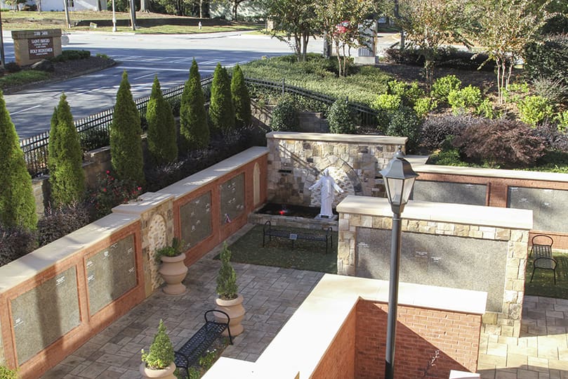 An overhead view of the St. Brigid Church Columbarium and Memorial Garden can be seen from a landing at the church’s sanctuary level. The grounds were designed by Atlanta-based landscape and planning architecture firm, HGOR, and the columbarium was built by Lovvorn Construction. The columbarium was completed and blessed by Archbishop Wilton D. Gregory in 2016. At full capacity, it will be able to hold 952 cremated human remains. Photo By Michael Alexander