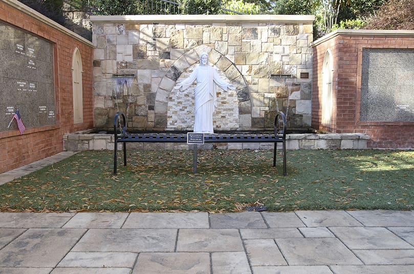 A ground level view of the St. Brigid Church Columbarium and Memorial Garden looks toward the statue of Jesus, displayed between the view and sound of flowing water. Photo By Michael Alexander