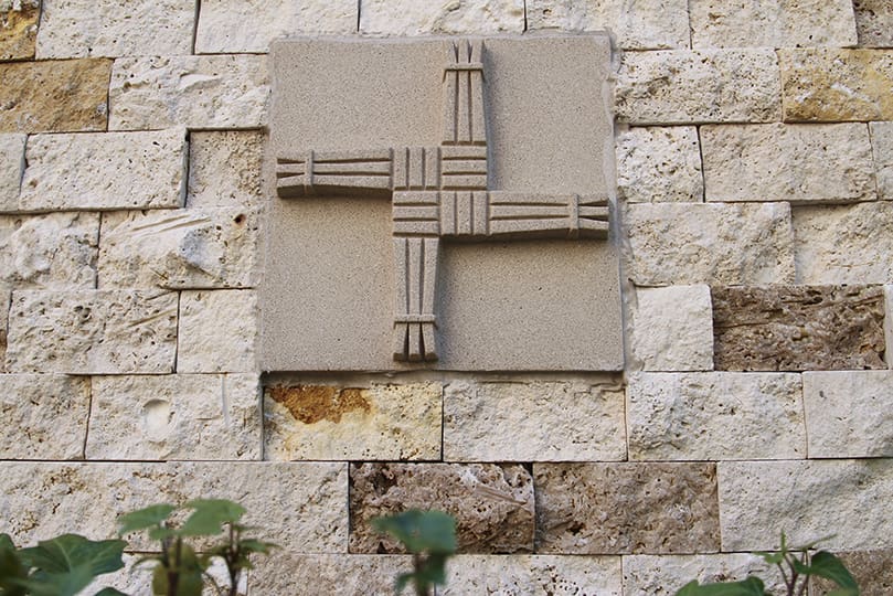 An image of St. Brigid’s cross is part of each small, stone niche along the wall of the St. Brigid Church Columbarium and Memorial Garden in Johns Creek. Photo By Michael Alexander