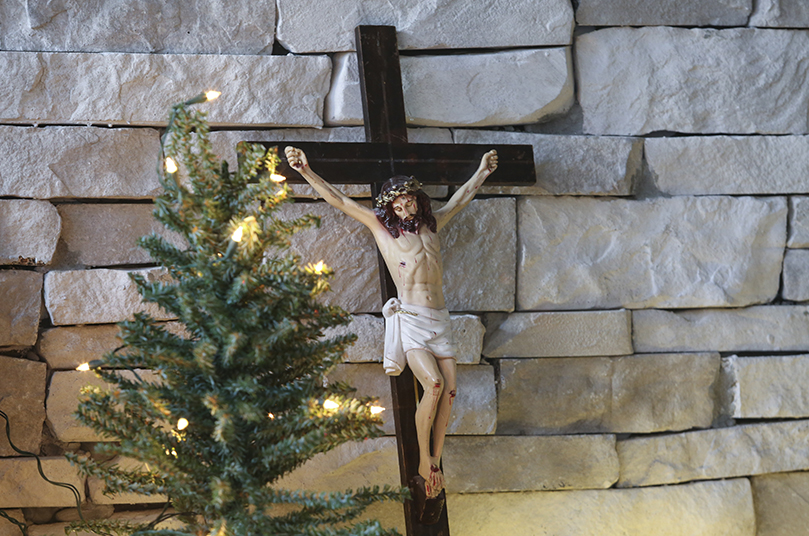 A crucifix is displayed next to a small, artificial Christmas tree during the Zenith Ministries retreat, held on the eve of the second Sunday of Advent. Photo By Michael Alexander
