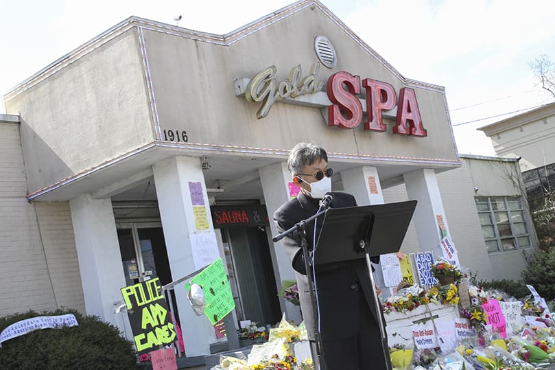 Father Kolbe Chung, the administrator of St. Andrew Kim Church, Duluth, leads a prayer during a March 21 interfaith prayer service at the Gold Spa, one of three Atlanta-area massage parlors where a mass shooter gunned down eight people five days earlier. Photo By Michael Alexander