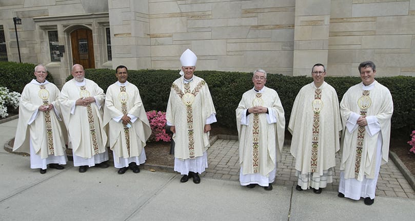 Seven of this year’s 16 jubilarians pose for a photograph before the March 30 Chrism Mass at the Cathedral of Christ the King, Atlanta. They include (l-r) Father Daniel Fleming, Father William Williams, Father José González, Bishop Bernard E. Shlesinger III, Father John Fallon, Father Paul Burke and Father John Howren. Father Fallon is a golden jubilarian and the other six clergy are silver jubilarians. Photo By Michael Alexander