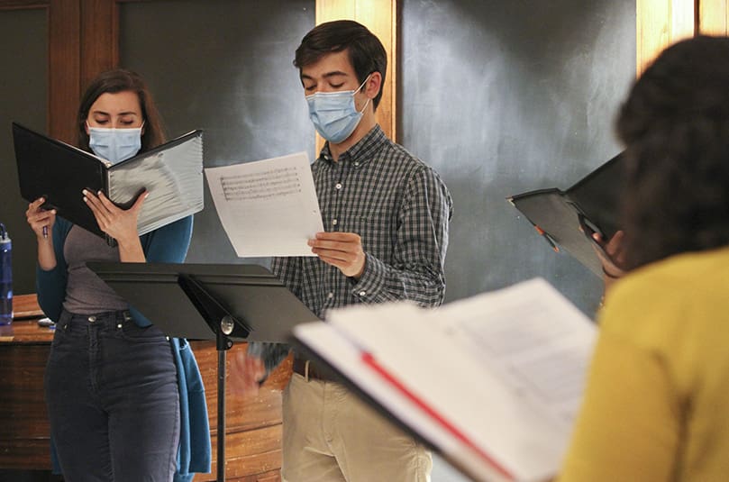 Genevieve Leopold, left, and Ben Dollar, center, join the other eight Concordi Laetitia Choir members in rehearsing "Dum Transisset Sabbatum,” which was written by the late English composer John Taverner. Photo By Michael Alexander