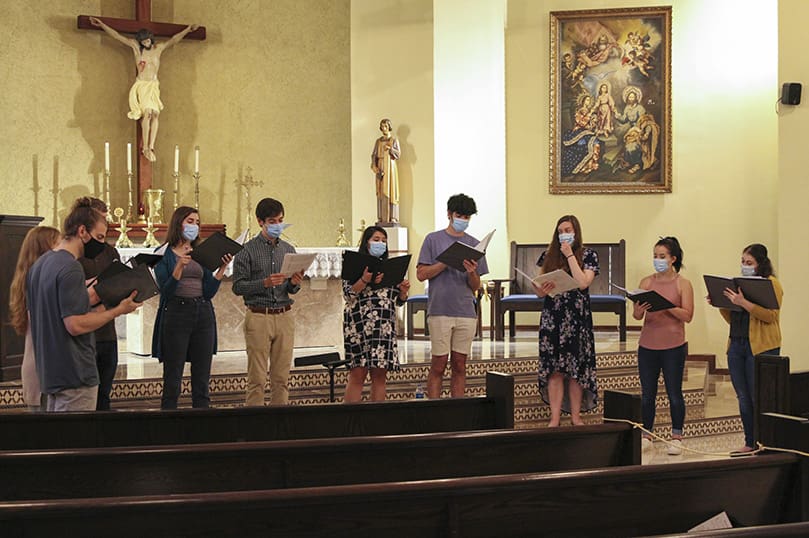 During rehearsal, April 14, Concordi Laetitia Choir members (l-r) Greg Leopold, Carrie Sturniolo, Connor Lawson, Genevieve Leopold, Ben Dollar, Valeska Lawson, Terrence Connors, Cristina Dinella, Anna Julia Gowasack and Alex Matlack sing "Dum Transisset Sabbatum,” one of the notable chorales by the late English composer John Taverner.