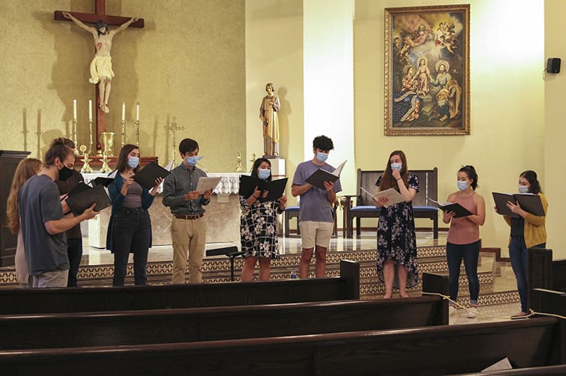 During rehearsal, April 14, Concordi Laetitia Choir members (l-r) Greg Leopold, Carrie Sturniolo, Connor Lawson, Genevieve Leopold, Ben Dollar, Valeska Lawson, Terrence Connors, Cristina Dinella, Anna Julia Gowasack and Alex Matlack sing 
