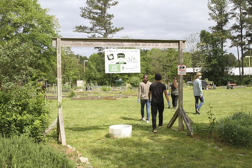 Volunteers return to the Stone Mountain Community Garden at VFW Park after a little break in the action. The community garden moved to its current location in 2011, but it came into existence in 2009. Photo By Michael Alexander