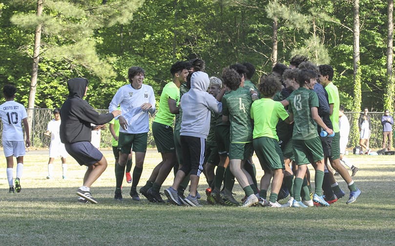 The Holy Spirit Preparatory soccer team celebrates a 2-1 soccer victory over Cristo Rey Atlanta on its home field April 21. Freshman Timi Browne scored the team’s winning goal in the second half. Photo By Michael Alexander