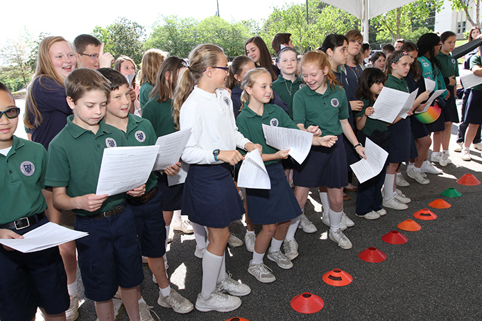 As the St. Catherine of Siena School praise band performs under a tent on the school parking lot, fourth, fifth and a few eighth grade students dance and sing along. There was also a school-wide picnic that included hot dogs, chips and Italian ice. It all took place during the 2016 Faith Rally on the feast of the school’s patron saint. Photo By Michael Alexander